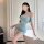 A woman poses elegantly beside a bathtub wearing a light blue qqny lace halter bodycon dress, perfect for seductive sleepwear...