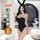 Woman modeling black lace sleepwear set with bunny ears, elegant sensual nightwear in modern bedroom setting.