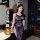 Woman wearing qqny pure allure lingerie set – elegant navy lace sleepwear with sheer panels and high slit, styled in modern b...