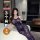 Woman in qqny pure allure lingerie set, elegant blue lace sleepwear, posing on bed in modern bedroom.
