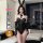 Woman wearing qqny pure allure lingerie set with bunny ears, fishnet stockings, and gloves in a modern bedroom.