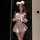 A woman models the qqny pure allure sleepwear set, featuring a cute pink sailor-style top with a bow and fluffy white bunny e...