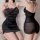 Woman modeling qqny pure allure black satin lingerie set with lace trim, sheer back, and adjustable straps.