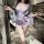 Woman wearing qqny pure allure sleepwear set, elegant lavender lingerie with floral print and flowing sleeves in modern kitch...