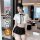 A woman models a stylish white blouse with a black skirt, featuring a bow tie and thigh-high stockings, set against a modern ...