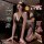 Woman in black lace qqny pure allure sleepwear set, elegant sensual lingerie with sheer robe and flirty feminine charm.