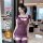 Woman wearing purple qqny pure allure sleepwear set with lace trim and bow details in a modern hotel room setting.