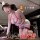 Woman in qqny pure allure sleepwear set, elegant seductive lingerie with lace details and nurse-themed design.