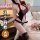 Woman wearing qqny pure allure burgundy sleepwear set with lace details, posing elegantly on a bed with floral decor.