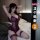 Woman modeling qqny pure allure sleepwear set, elegant purple lace lingerie with thigh-high stockings on bed.