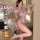 Woman modeling qqny pure allure sleepwear set – elegant purple lace lingerie in luxury bedroom setting.