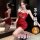 Woman modeling red qqny pure allure sleepwear set, elegant lingerie with lace detail, holding wine glass in mirror reflection...