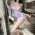 Woman wearing qqny pure allure sleepwear set, elegant sheer lingerie with butterfly print and sash tie.