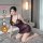 Woman modeling qqny pure allure sleepwear set — elegant lace and silky lingerie in purple, designed for luxury bedroom wear.