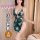 Woman modeling green floral qqny pure allure sleepwear set, elegant seductive lingerie with pearl straps and side tie detail.