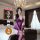 Woman in purple lace lingerie set sitting on bed, featuring elegant qqny pure allure sleepwear with sheer sleeves and matchin...