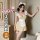 Woman modeling qqny pure allure sleepwear set — soft satin chemise with ruffles, matching briefs, bunny ears, and thigh-highs...