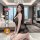 A woman poses in a luxurious setting wearing a black lace sleepwear set, featuring a sheer chemise and matching briefs, ideal...