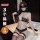 Woman wearing qqny pure allure black lace lingerie set with garter stockings and eye mask, luxury sensual sleepwear.