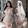 Woman wearing a delicate white lace dress with ruffles, thigh-high stockings, and a veil, embodying elegance and allure.