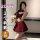 Woman modeling qqny pure allure lingerie set with red bow top and pleated skirt, holding plush toy in mirror selfie.