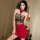 Woman wearing qqny pure temptation lingerie set – red skirt with black lace top and bow, stylish bedside secretary sleepwear.