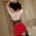 Woman wearing qqny pure temptation lingerie set – red skirt with black lace waistband, posing beside bed with wine glass.