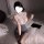 Woman in qqny pure & tempting lingerie set - secretary style lace sleepwear with pencil skirt, holding glasses on bed.