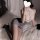 Woman in qqny pure & tempting lingerie set, featuring lace top and pencil skirt, posed seductively on bed.
