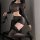Woman in qqny seductive lounge set – pure allure, featuring sheer black top and shorts with lace-trimmed stockings.