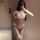 Woman modeling qqny seductive lounge set - white lace lingerie with pearls, bows, and thigh-high stockings for luxury sensual...