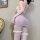 Woman in qqny seductive maid lingerie set with fishnet stockings, backless pink dress, and lace garters.