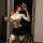 A woman poses with a whip, wearing a white crop top and black mini skirt from the qqny seductive secretary outfit. the ensemb...