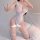 A woman poses wearing a sheer white bodysuit with lace detailing, featuring an open-crotch design and thigh-high stockings. t...