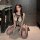 Woman wearing qqny sexy sheer lingerie set with mesh bodysuit and fishnet stockings, kneeling on floor.