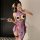 Woman in purple qqny silk cheongsam lingerie set with open-crotch bralette, matching robe, pearls, and floral hairpiece.