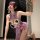 Woman in purple silk cheongsam lingerie set with open-crotch bralette and matching robe, holding lace fan for romantic date n...