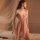 Woman in a pink qqny lingerie set with lace details, featuring an underwire push-up bra and matching panty for sensual appeal...