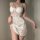 Woman wearing white lace cami set with deep v and backless design, elegant sleepwear for women.