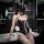 Woman in black rabbit girl lingerie set with lace trim, bunny ears, and garter stockings posing by bathtub.