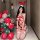 Woman in red rabbit girl lingerie set with bunny ears, posing beside christmas balloons. sexy bondage-style nightclub costume...