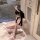 Woman in pink rabbit girl lingerie set with bunny ears, sitting on floor holding plush toy—sexy open-crotch bodysuit for role...