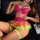 Woman wearing vibrant pink and neon green rainbow lace petticoat lingerie set with heart embroidery, sheer mesh skirt, and ma...