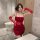 A woman poses confidently in a red christmas deer print velvet lingerie set, featuring sheer lace sleeves and a form-fitting ...