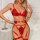 Red lace garter belt set with intricate detailing and gold accents, showcasing a sexy european-american style shapewear desig...