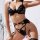 Woman wearing black lace garter belt set with gold chains, featuring sexy shapewear and stocking holders in style erotic li...
