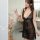 A woman models a black lace lingerie set with deep v-neckline and sheer fabric, perfect for nightclub-style erotic sleepwear.