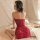 Woman in red lace sleepwear, sheer cheongsam-inspired one-piece outfit, sitting on bed with soft lighting and elegant ambianc...