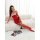 Woman wearing red lace sleepwear set, sheer bodycon lingerie with fishnet stockings, posing on white couch.