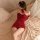 A woman lounges on a bed wearing a red sparkly bunny costume, perfect for festive occasions like christmas or new years celeb...